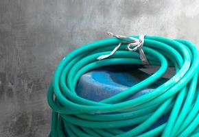 the green water hose is neatly rolled up photo