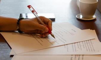 proofreading paper on table photo