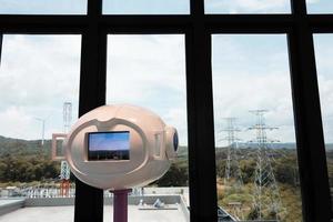 modern telescope in front of wide windows photo