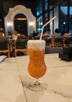 cold Thai tea on table in restaurant photo