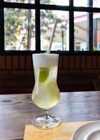 glass of honey lemon on wooden table photo