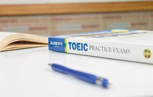 TOEIC practice exams book on white table photo