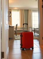 orange brand new luggage arrive in luxury hotel room photo