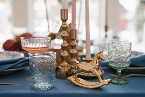 Vintage horse, glass glasses and candlesticks in the festive setting of the Christmas table photo