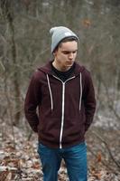 Young handsome man walking in the autumn forest photo