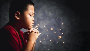 Christianity religion concept. Christian life crisis prayer to god. Young boy pray for god blessing to wishing have better life. Hand worship to god. Begging for forgiveness and believe in goodness. photo