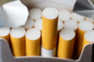 A close up image of an open package of cigarettes. photo