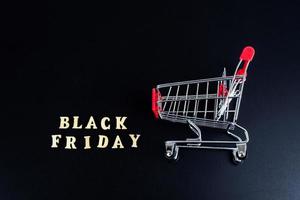 Wooden letters text BLACK FRIDAY in front black background, copy space, banner Top view Flat lay seasonal sale, retail, shopping concept. Black friday sale photo