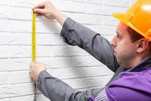 a man with a centimeter on a white background photo