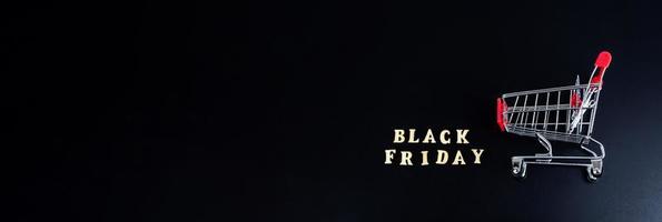 Wooden letters text BLACK FRIDAY in front black background, copy space, banner Top view Flat lay seasonal sale, retail, shopping concept. Black friday sale photo