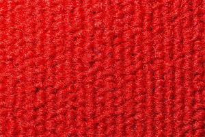 Seamless close up of monochrome red carpet texture background from above. photo