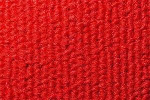 Seamless close up of monochrome red carpet texture background from above. photo