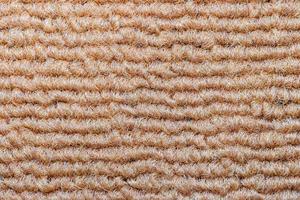 Seamless close up of monochrome beige carpet texture background from above. photo