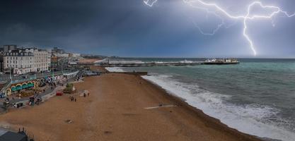 Beautiful Brighton beach view of stormy weather with thunderstorm and lightening in Brighton, UK. Town by the ocean in England. photo