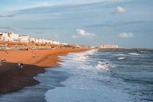 People walking down the promenade near the beach in Brighton. photo