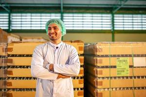 worker presenting products on the production line in the beverage factory. Manufacturer checks quality of food industry. photo