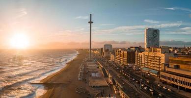 Magical sunset aerial view of British Airways i360 viewing tower pod with tourists in Brighton photo