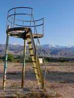 On an empty playground in Cholpon Ata, Kyrgyzstan, with mountains in the background photo