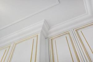 Detail of corner ceiling cornice with intricate crown molding. photo