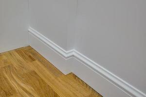 Detail of corner flooring with intricate crown molding and plinth. photo