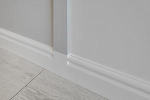 Detail of corner flooring with intricate crown molding and plinth. photo