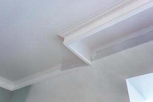 Detail of corner ceiling with intricate crown molding. photo