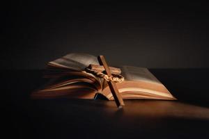 Spirituality, Religion and Hope Concept. Holy Bible and Cross on Desk. Symbol of Humility, Supplication,Believe and Faith for Christian People photo