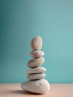 Natural Pebble Stone Stack. Metaphor of Balancing Body, Mind, Soul and Spirit. Mental Health Practice. Harmony, Calm, Mind, Life Relaxing and Living by Nature Concept. Vertical image photo