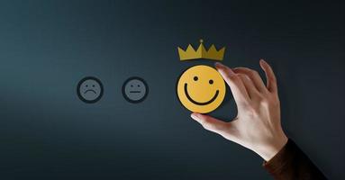 Customer Loyalty Concept. Client Experiences. Happy Customer giving Positive Services Rating for Satisfaction present by Smiling Face and Crown photo