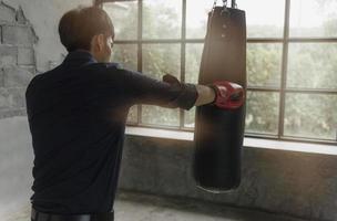 Strong boxer punching sandbag photo