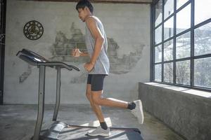 A man walking and exercising on a treadmill. photo