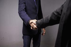 Two confident businessman shook hands during office meetings. photo