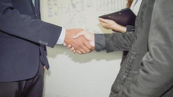 Two confident businessman shook hands during office meetings. photo