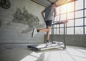 A man walking and exercising on a treadmill. photo