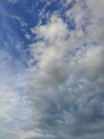 Blue sky with puffy clouds background photo