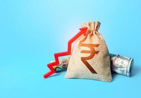 Indian rupee money bag and red up arrow. Economic growth, GDP. Increase in the deposit rate. Increase income and business efficiency. Inflation acceleration. Investments. Rise in profits, budget fees. photo