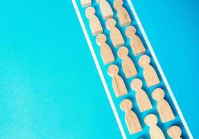 A chain of people within the boundaries of the lines. Concept of conformism, control and obedience. Unchanging course of development. Authoritarianism and despotism. Control of the human masses. photo