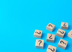 Scattered blocks with a question mark. Lots of unknown facts. Analytics and analysis of information. Curiosity, exploration. Induction, deduction. Confusing business. Questions and problem solving. photo