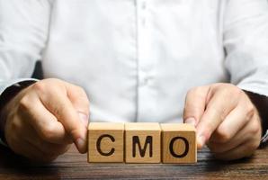 Man holds abbreviation CMO. Marketing strategy of the company. Post top manager Chief Marketing Officer. PR and advertising, establishing public relations and the media photo