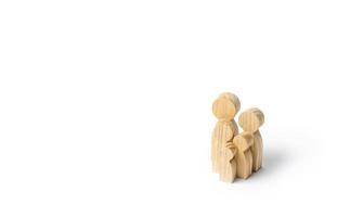 Wooden figurines of the family on a white background. Family values and health. Adoption and custody of children. Social support, demography, sociology. Upbringing and education. Together concept photo