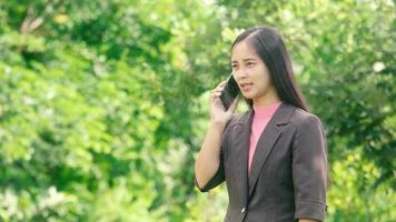 Young businesswoman making a call with a smile video