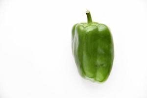 Juicy green and yellow pepper fruits on a white background. Beautiful shiny and delicious pepper. photo