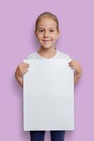 Girl holding empty blank vertical A3 poster for mockup, ad or text presentation photo