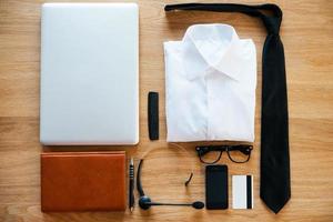 Business collection. Top view of clothing and diverse personal accessory for businessman laying on the wooden grain photo