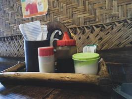 A set of condiments provided at the Javanese noodle restaurant, which consists of soy sauce, salt and pepper. photo