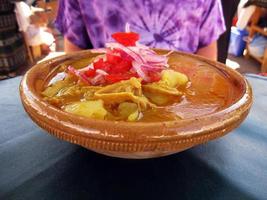 Beef stew with potatoes served in a clay bowl, Bolivian food photo