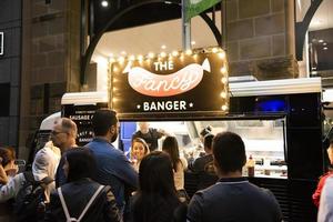 SYDNEY, AUSTRALIA 2019 Night Street food festival Sydney on Pitt street set to come to life, food stall with people on the line. photo