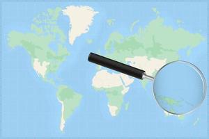 Map of the world with a magnifying glass on a map of Micronesia. vector