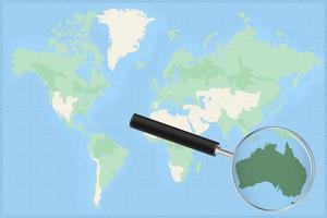 Map of the world with a magnifying glass on a map of Australia. vector