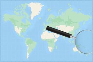 Map of the world with a magnifying glass on a map of Nauru. vector